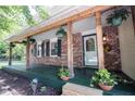 Front porch with brick facade, plants, and decorative accents at 6028 Thornwood Ct, Indianapolis, IN 46250