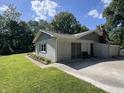 Home featuring an attached garage with ample parking space and a well-kept lawn with manicured landscaping at 6238 E Southport Rd, Indianapolis, IN 46237