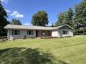Attractive home showcases a lush green lawn and a charming exterior with well-maintained landscaping at 6238 E Southport Rd, Indianapolis, IN 46237