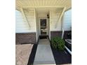 Charming entryway featuring a glass storm door, brick accents, and well-maintained landscaping for a welcoming first impression at 6504 Potomac Square Ln, Indianapolis, IN 46268