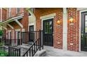 Inviting front door of a brick townhouse with elegant lighting fixtures at 6592 Reserve Dr, Indianapolis, IN 46220