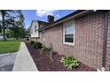 Close up on a brick home's exterior, showcasing the meticulously maintained landscaping at 6602 S 400 W, Columbus, IN 47201