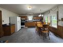 The kitchen features light wood cabinets, classic appliances, and a dining area with a wooden table at 6895 N County Road 625 E, Brownsburg, IN 46112