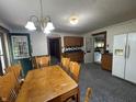 The kitchen offers light wood cabinetry, a functional layout, and a dining area illuminated by a charming chandelier at 6895 N County Road 625 E, Brownsburg, IN 46112