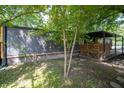 A peaceful backyard setting with mature trees surrounding the well-maintained home at 71 E Cove Ct, Cicero, IN 46034