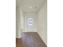 Bright entryway showcasing beautiful wood floors and a welcoming white door with glass panels at 7195 Rose Hill Ave, Brownsburg, IN 46112