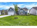 Beautiful blue single-Gathering home with a manicured lawn, attached garage and lovely landscaping at 7195 Rose Hill Ave, Brownsburg, IN 46112