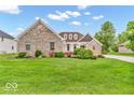 Charming brick home with a lush green lawn and thoughtfully arranged landscaping, creating a welcoming curb appeal at 720 Willow Pointe North Dr, Plainfield, IN 46168