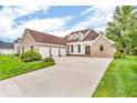 Stunning brick home boasts a spacious three-car garage and a meticulously maintained lawn, enhancing its curb appeal at 720 Willow Pointe North Dr, Plainfield, IN 46168