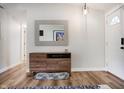 Bright entryway featuring a wooden console table, decorative mirror, and hardwood floors, for a welcoming atmosphere at 7234 Fairwood Dr, Indianapolis, IN 46256