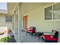 Relaxing covered patio featuring cozy seating and views of the landscaped backyard at 7401 N Layman Ave, Indianapolis, IN 46250