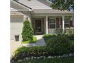 Inviting front porch with decorative shutters and a landscaped garden adding to the curb appeal at 7608 Mather Ln, Indianapolis, IN 46239