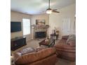 Cozy living room with a traditional fireplace and plush leather seating at 7608 Mather Ln, Indianapolis, IN 46239