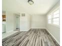 Bright living room with neutral walls, wood-look floors, and ample natural light at 8210 Patton Dr, Lawrence, IN 46226