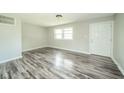 Spacious living area featuring gray-toned flooring, fresh paint, and a welcoming entrance at 8210 Patton Dr, Lawrence, IN 46226