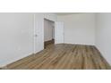 Clean bedroom featuring hardwood floors, white walls, and doors leading to other rooms at 8344 Leander Ave, Zionsville, IN 46077