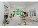 Bright living room with a fireplace, built in shelving, and large windows overlooking the yard at 9190 Hastings Trce, Indianapolis, IN 46234