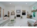 Open concept living room featuring a fireplace, built in shelves, and large window at 9190 Hastings Trce, Indianapolis, IN 46234