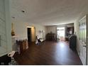 A spacious living room showcasing laminate flooring and abundant natural light at 1001 Paradise Ct # F, Greenwood, IN 46143