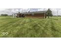Expansive backyard with a covered patio, ideal for outdoor entertaining and relaxation in a serene setting at 10769 Shelbyville Rd, Indianapolis, IN 46259