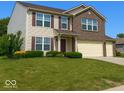 Charming two-story home with a well-manicured lawn and beautiful landscaping at 10780 Affirmed Dr, Indianapolis, IN 46234
