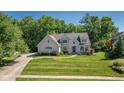 Stunning two-story home with a lush green lawn and mature trees, offering a picturesque setting at 11350 Old Stone Dr, Indianapolis, IN 46236