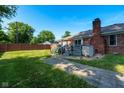Brick home featuring a fenced backyard with a deck and a brick chimney at 12113 N Rooker Rd, Mooresville, IN 46158