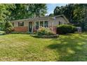 Well-maintained home featuring beautiful landscaping and a welcoming entrance at 1302 N Furman Ave, Indianapolis, IN 46214