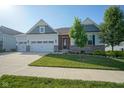 Attractive home with a well-manicured lawn, two-car garage, and appealing architectural accents at 16235 Natures Way, Westfield, IN 46074