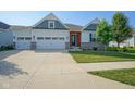 Attractive home with a well-manicured lawn, two-car garage, and appealing architectural accents at 16235 Natures Way, Westfield, IN 46074