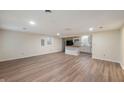 Open concept living room features wood-look floors, recessed lighting, and kitchen bar at 2009 N New York Ave, Muncie, IN 47304