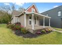 Attractive home with a spacious covered porch, well-maintained landscaping, and inviting entrance at 2026 E 10Th St, Indianapolis, IN 46201