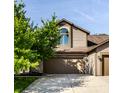 Charming two-story home with a well-manicured lawn and an attached two-car garage at 2247 Frisco Pl, Indianapolis, IN 46240