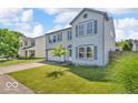 Beautiful two-story home with a green lawn and mature tree in the front yard at 2309 Westmere Dr, Plainfield, IN 46168