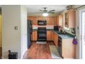 Traditional kitchen features wood cabinets, black appliances, and a tile backsplash at 2355 Collins Way, Greenfield, IN 46140