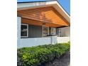 A close up of the front porch, showcasing a wood plank ceiling and freshly painted white brick at 2543 Union St, Indianapolis, IN 46225