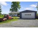 The detached garage is next to the ranch style home and vintage truck at 2911 N 200 W Rd, Franklin, IN 46131
