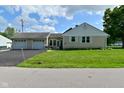 This home has an attached two car garage with a well maintained lawn and paved driveway at 3059 Tansel Rd, Indianapolis, IN 46234