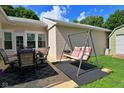 Outdoor patio with a dining set and a swing, perfect for relaxing and enjoying the outdoors at 3059 Tansel Rd, Indianapolis, IN 46234