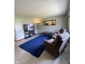 Cozy living room featuring plush seating, a large TV, and a comfortable area rug at 31 S Sugar Creek Dr, New Palestine, IN 46163