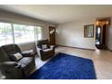Bright living room with comfortable seating, large window, and open access to other rooms at 31 S Sugar Creek Dr, New Palestine, IN 46163