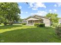 Inviting single-story home with a lush green lawn and mature trees in a peaceful setting at 3304 Coffey St, Indianapolis, IN 46217