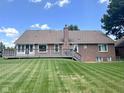 Expansive backyard with a well-maintained deck and lush green lawn at 3975 Keyway Dr, Greenwood, IN 46143