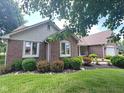 Charming brick home featuring well-maintained landscaping and classic architectural details at 3975 Keyway Dr, Greenwood, IN 46143