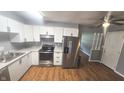Modern kitchen featuring white cabinets, stainless steel appliances, and granite countertops at 4614 Runyon Lake W Dr, Greenwood, IN 46143