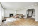 Bright living room boasts hardwood floors, a cozy fireplace, neutral walls and an arched doorway at 5430 N Kenwood Ave, Indianapolis, IN 46208