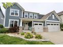 Inviting front porch with a cute bench and a landscaped garden in front of a two-car garage at 5473 Forest Glen Dr, Brownsburg, IN 46112