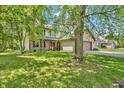 Spacious two-story home with a large front yard and mature trees at 6329 Whitaker Farms Dr, Indianapolis, IN 46237