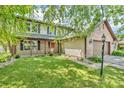Traditional two-story home featuring a covered front porch and a lush, green lawn at 6329 Whitaker Farms Dr, Indianapolis, IN 46237