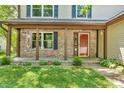 Inviting front porch with brick columns and decorative accents at 6329 Whitaker Farms Dr, Indianapolis, IN 46237